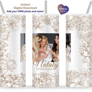 May include: A cylindrical tumbler with a white background featuring dark tan line art of various flowers. The design includes a customizable photo area and the text "Nataly bridesmaid" in a script font. A silver straw extends from the top.