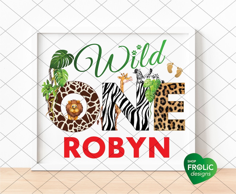 May include: A framed print with the words "Wild One Robyn" in green and red. The letters are decorated with animal prints and illustrations of a lion, giraffe, and zebra. Green leaves and paw prints add to the jungle theme.