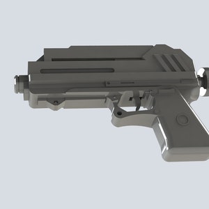 K&ouml;nnte beinhalten: Eine graue, futuristisch aussehende Pistole mit rechteckigem K&ouml;rper und abgerundetem Griff. Die Waffe hat einen Abzug, ein Visier und einen Knopf auf der R&uuml;ckseite. Das Design ist schlank und modern, mit metallischem Aussehen.