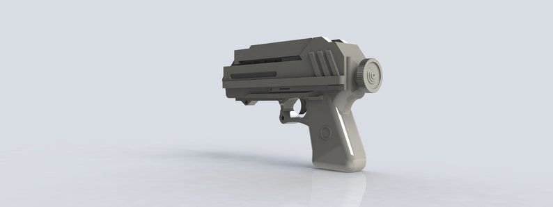 K&ouml;nnte beinhalten: Eine hellgraue, futuristisch aussehende Pistole mit einem rechteckigen Oberteil und einem kreisf&ouml;rmigen Element an der Seite. Der Griff hat eine abgerundete Form mit einem kreisf&ouml;rmigen Design. Das Gesamtdesign deutet auf ein Science-Fiction- oder Cosplay-Requisit hin.