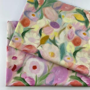 May include: Two pieces of fabric with a floral design. The pattern showcases various flowers in pink, purple, yellow, and orange, with green leaves. The fabric has a soft, painterly appearance.