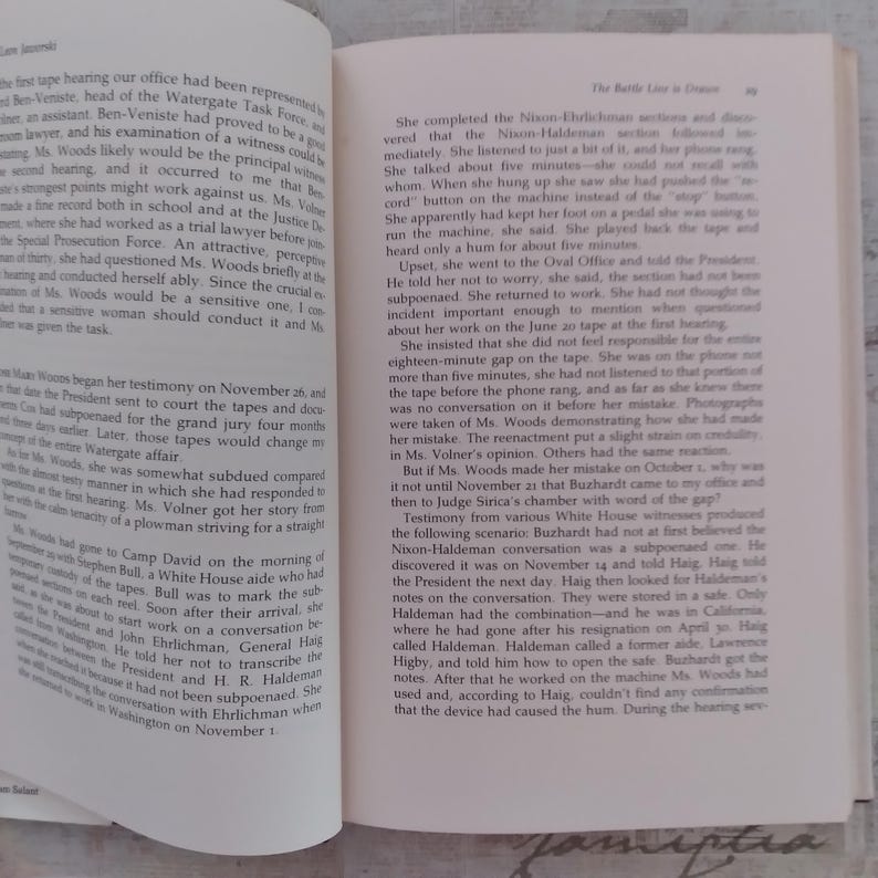 May include: An open book with two pages of printed text in black ink on off-white paper. The left page features a paragraph starting with the words The first tape, while the right page displays a chapter titled The Battle Line is Drawn.