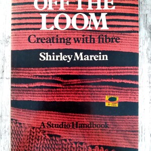 May include: A book titled "OFF THE LOOM" with the subtitle "Creating with fibre" by Shirley Marein. The cover features a red and black woven design. The book is a Studio Handbook.
