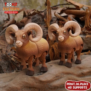 May include: Two brown ram figurines with large, curved horns. The rams have tan bodies and dark brown legs and hooves. The image includes the text "TOONZ FACTORY 3d Printing Service" and "PRINT.IN.PLACE NO SUPPORTS".