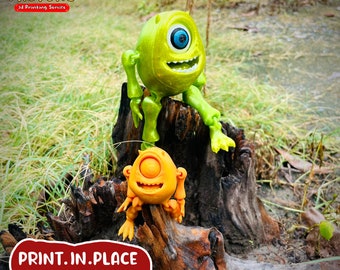May include: Two 3D printed figures of popular cartoon characters, one green and one orange, are sitting on a tree stump. The text "PRINT.IN.PLACE NO SUPPORTS" is visible in the image.