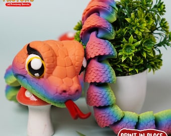 May include: A rainbow-colored 3D printed snake with a cute face and a red tongue. The snake is curled up and has a textured, scaly appearance. The text "PRINT.IN.PLACE NO SUPPORTS" is visible in the image.