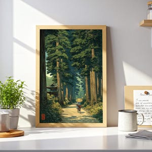 Japanese-inspired art print of an elderly lady cycling through a lush green forest, traditional style poster with calming nature tones, shown framed and displayed in a white kitchen