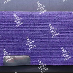 May include: Purple horse saddle pad with a black leather patch and the text "The Tack N Pad Store" repeated throughout.