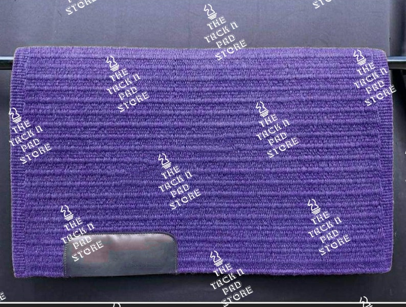May include: Purple horse saddle pad with a black leather patch and the text "The Tack N Pad Store" repeated throughout.