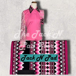 May include: Pink and black horse saddle pad with a geometric pattern. The pad has the text "Jack N Pad" printed on it. A pink button-up shirt with white lace sleeves is also pictured.