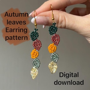 May include: A pair of long, beaded earrings in the shape of autumn leaves. The earrings feature a variety of colors, including green, red, orange, silver, and gold. The text "Autumn leaves Earring pattern" and "Digital download" are visible.