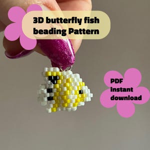 May include: A small, beaded butterfly fish pendant in yellow, white, and black, held by a hand with a pink manicure. The pendant is made with small beads. Text on the image reads "3D butterfly fish beading Pattern" and "PDF instant download."