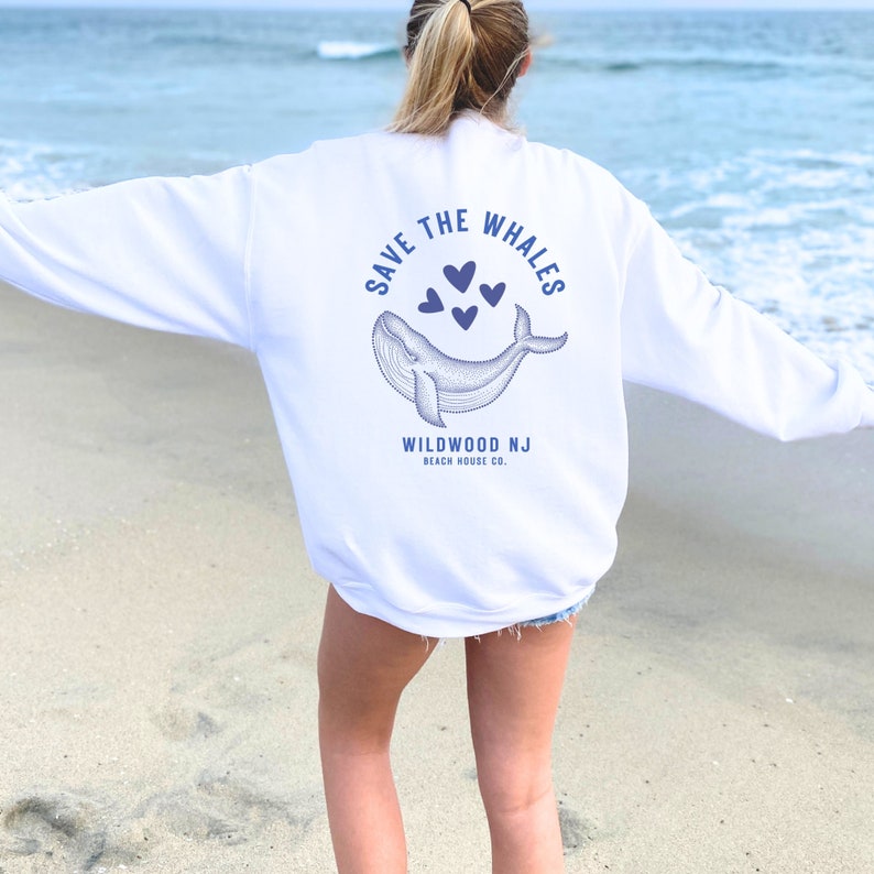 May include: White sweatshirt with a blue whale graphic and the text "Save the Whales" and "Wildwood NJ Beach House Co."