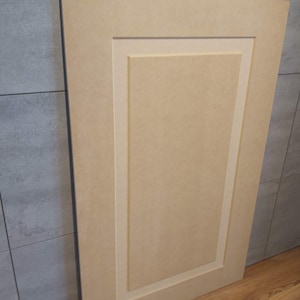 May include: A light beige wood panel with a raised, rectangular design. The panel has a simple, elegant look and is perfect for adding a touch of sophistication to any room.