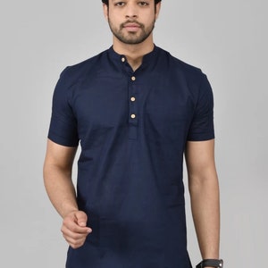 May include: A navy blue short-sleeved shirt with a mandarin collar and a single button closure. The shirt has a pocket on the left side.
