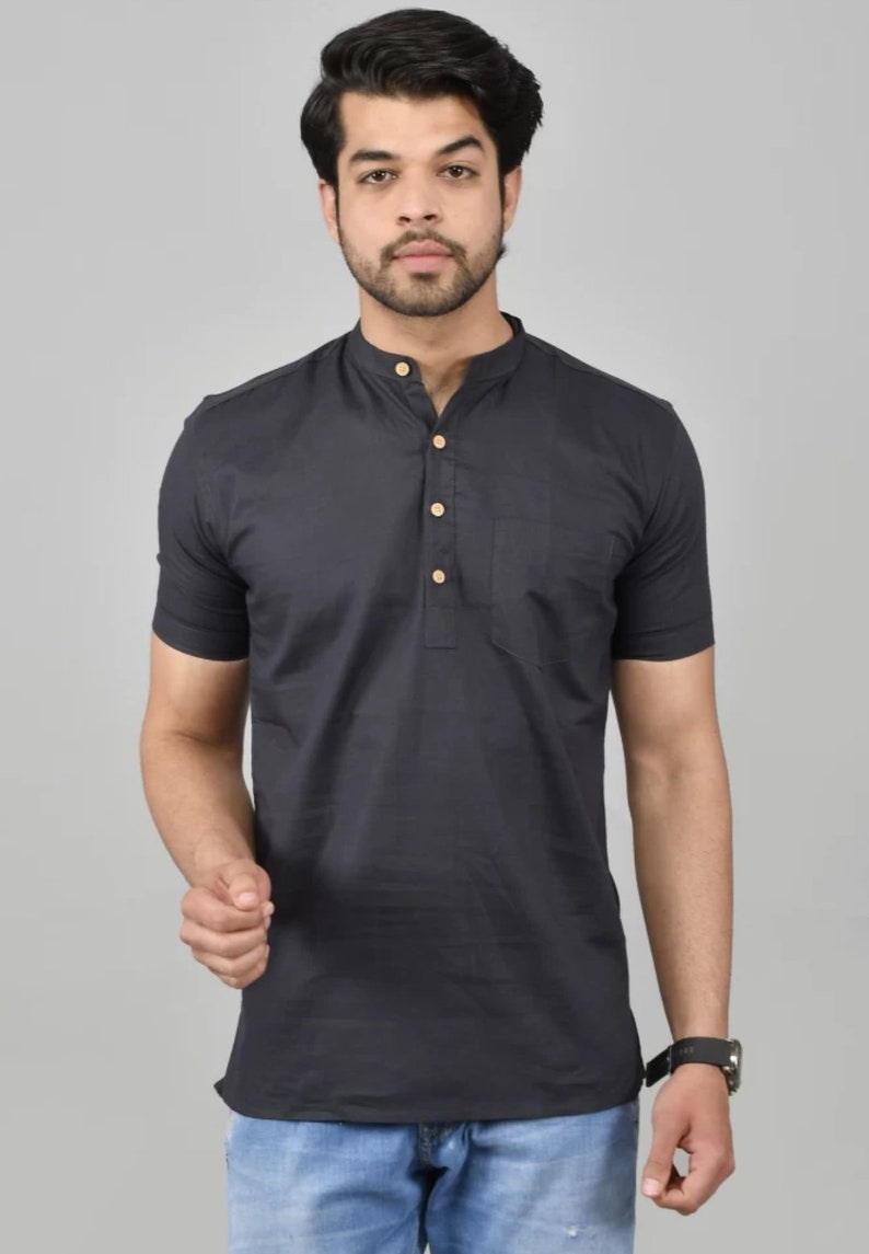 May include: A black short-sleeved collared shirt with a button placket and a single pocket on the left chest. The shirt has a mandarin collar and is made of a lightweight fabric.