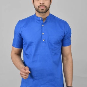 May include: A royal blue short-sleeved collared shirt with a single button placket and a chest pocket.