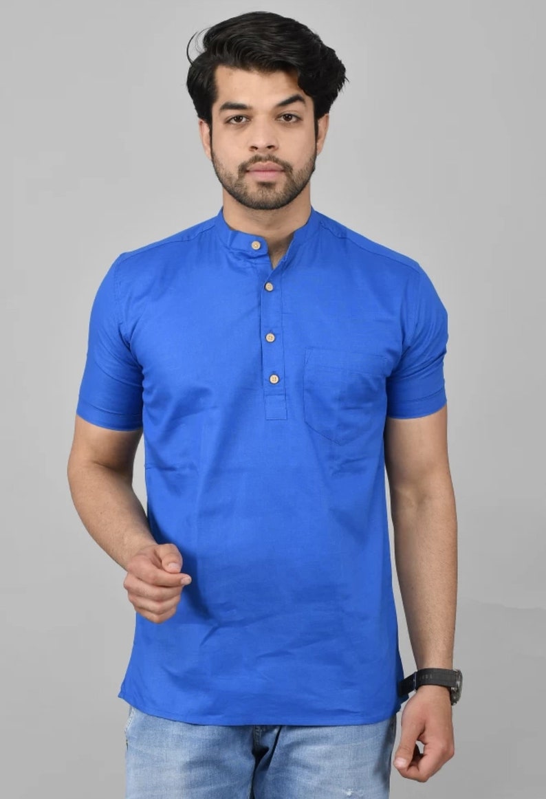 May include: A royal blue short-sleeved collared shirt with a single button placket and a chest pocket.