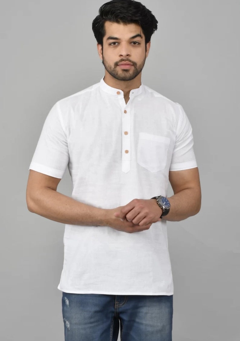 May include: A white short-sleeved collared shirt with a button-up placket and a single pocket on the left chest. The shirt has a mandarin collar and is made of a lightweight fabric.