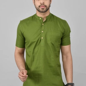 May include: A short-sleeved green shirt with a mandarin collar and a single button closure. The shirt has a pocket on the left side.