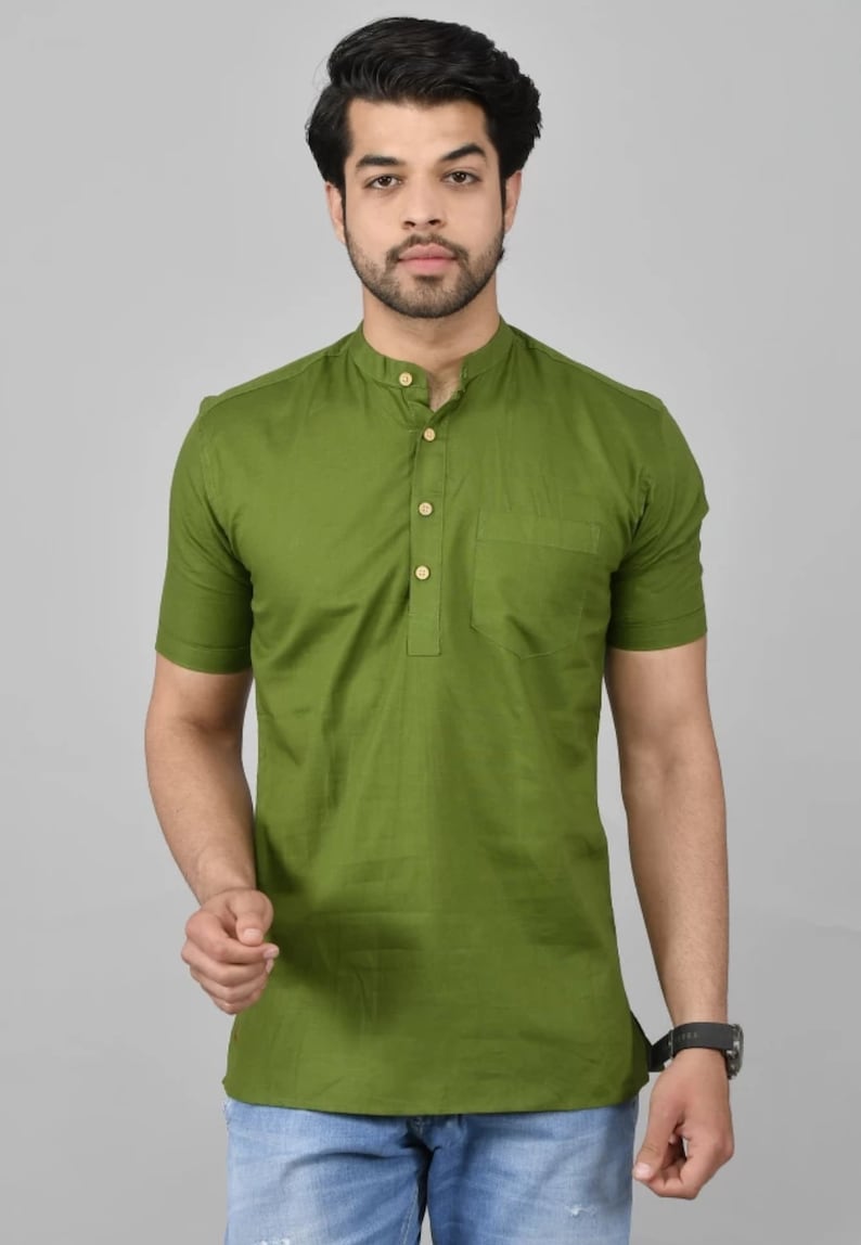 May include: A short-sleeved green shirt with a mandarin collar and a single button closure. The shirt has a pocket on the left side.