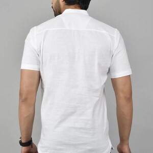 May include: A white short-sleeved button-down shirt with a mandarin collar.