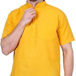 May include: A yellow short-sleeved collared shirt with a single button closure and a pocket on the left side.