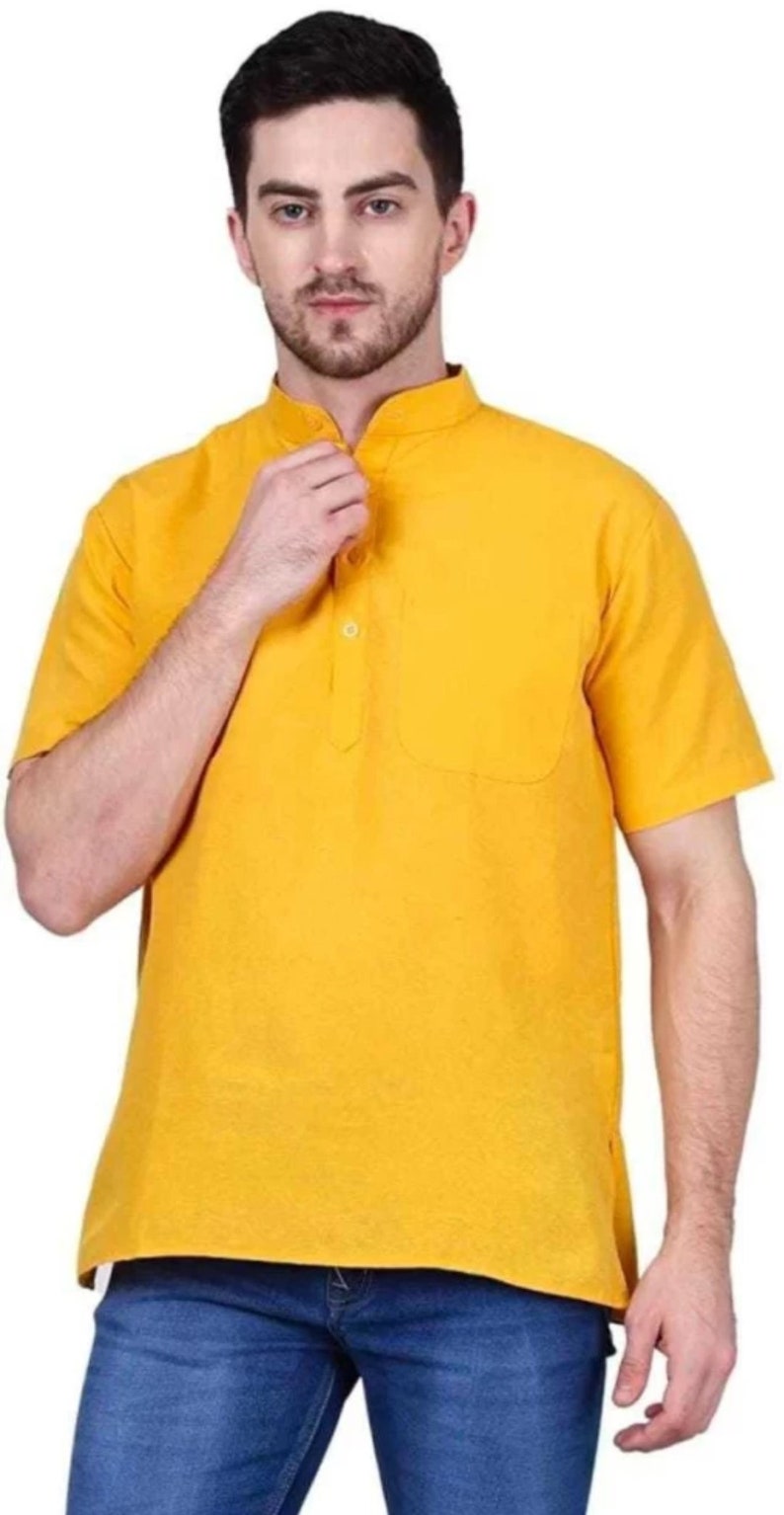 May include: A yellow short-sleeved collared shirt with a single button closure and a pocket on the left side.