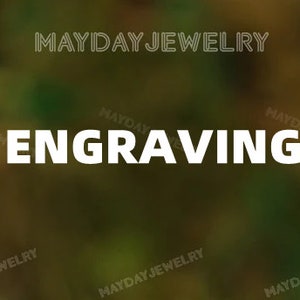May include: The image displays the word "ENGRAVING" in bold, white capital letters. The text is centered and prominent. The brand name "MAYDAY JEWELRY" is repeated in a smaller font around the edges of the image.