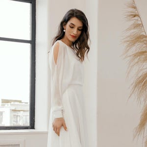 Boat neck chiffon wedding dress with sheer long sleeves and flowing A-line skirt