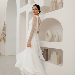 Simple and romantic wedding dress with sleeves.