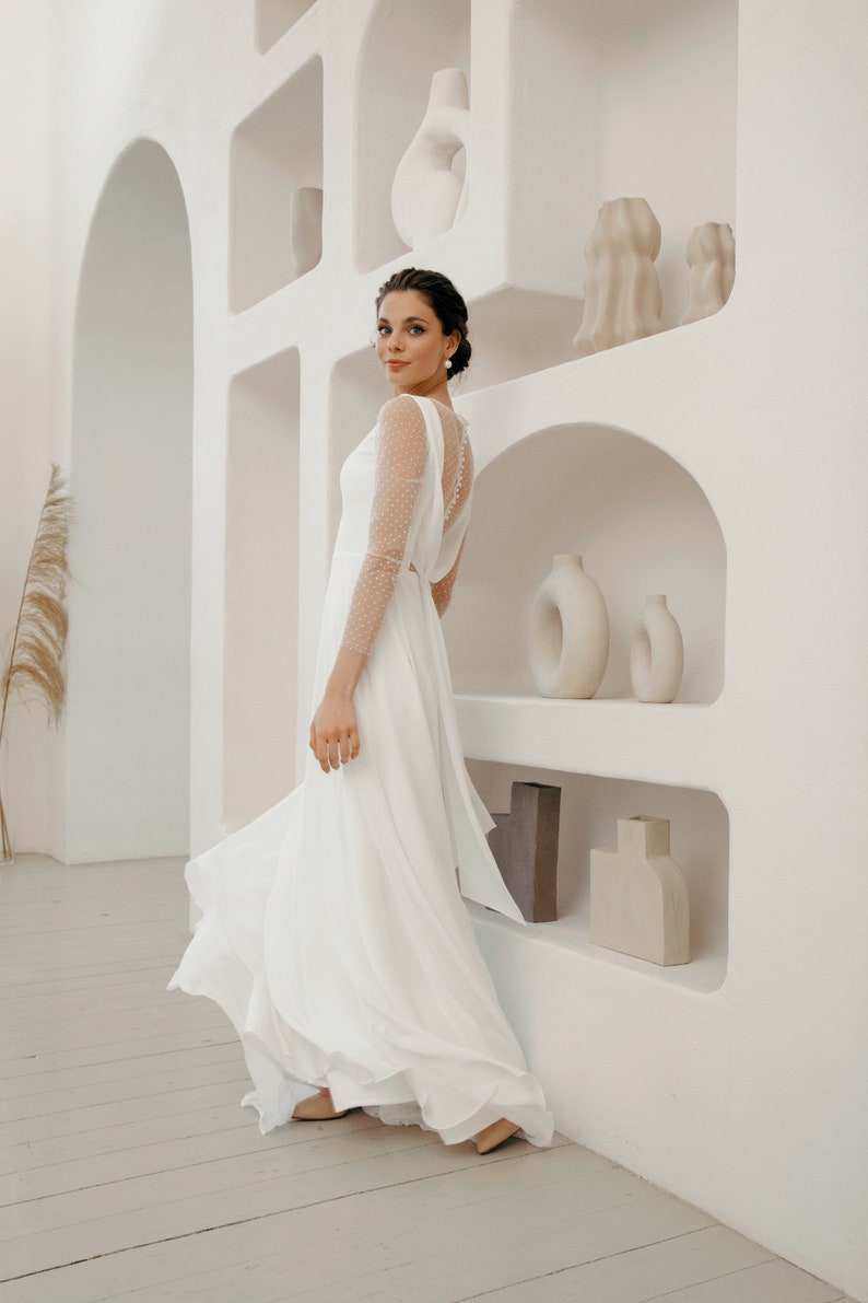 Simple and romantic wedding dress with sleeves.