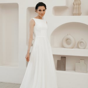 Simple and romantic wedding dress with sleeves.