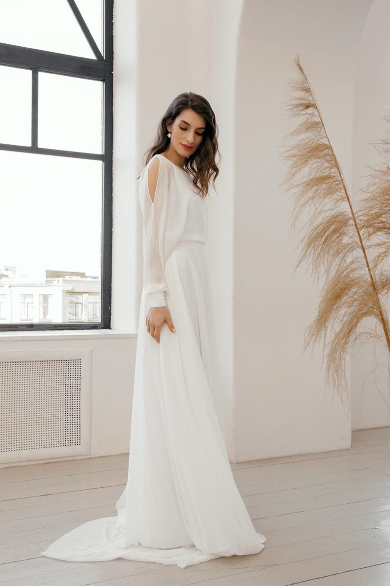 Boat neck chiffon wedding dress with sheer long sleeves and flowing A-line skirt