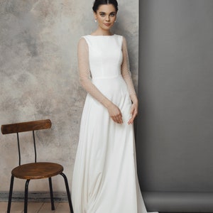 Simple and romantic wedding dress with sleeves.