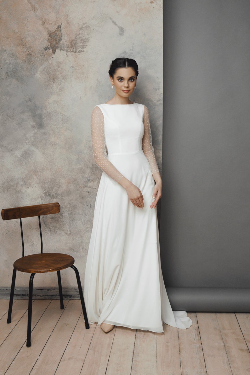 Simple and romantic wedding dress with sleeves.