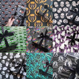 May include: Nine different designs of wrapping paper featuring various spooky and fun themes. The designs include bats, cupcakes, ghosts, skeletons, leopard print, and more. Each design is paired with a black ribbon.