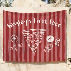 May include: A red and pink striped wall tapestry with the text "Wrigley's First Slice" in white script. A white illustration of a pizza slice with toppings is centered below the text, with additional food illustrations.