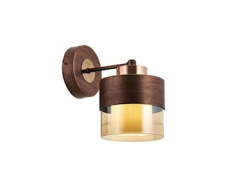 May include: A copper-toned wall sconce with a cylindrical shade featuring a textured finish and a clear glass diffuser. The sconce has a swivel arm for adjustable lighting.