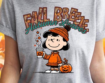 May include: A gray t-shirt with a graphic of a cartoon character holding a cup of coffee and a pumpkin. The text "Fall Breeze Autumn Leaves" is printed on the shirt.