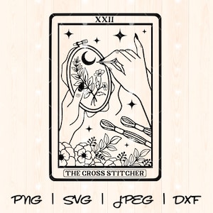 May include: Black and white illustration of a tarot card with the number XXXII and the words "The Cross Stitcher". The card depicts a hand holding a needle and thread, stitching a crescent moon and flowers into a hoop.