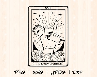 May include: Black and white illustration of a tarot card with the number XVII and the text "THE LADY BARBER". The card depicts a hand holding a pair of clippers in a rock and roll hand gesture.