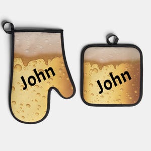 May include: A kitchen oven mitt and pot holder set. The design features a beer-like pattern with bubbles and the name "John" in black text. The edges are trimmed with black fabric.