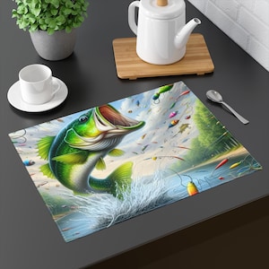 May include: A rectangular placemat featuring a vibrant illustration of a largemouth bass leaping out of the water. The fish is green and white, with an open mouth. Fishing lures and lines are scattered around the fish, with a blue sky background.