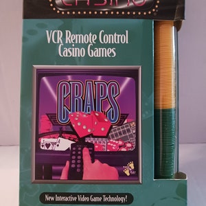 May include: A box for a VCR game called "VCR Casino" featuring a remote control and a screen showing the game "Craps". The box is green and yellow with the text "New Interactive Video Game Technology! Works In Your VCR!"
