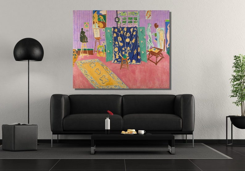 May include: A painting depicting a room with a pink floor, a blue rug, and a blue curtain with floral designs. There are several figures in the room, including a nude figure standing on a platform, a figure sitting on a stool, and a figure standing near a table. The painting is framed and hanging on a wall.