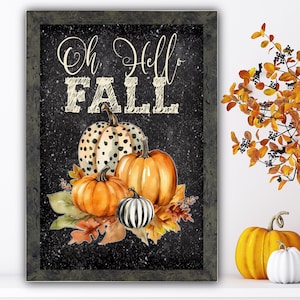 May include: A black chalkboard sign with white text that reads "Oh Hello Fall". The sign is decorated with three pumpkins, one with a black and white spotted pattern, one orange, and one black and white striped. The pumpkins are surrounded by fall leaves.