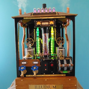 May include: A steampunk-style machine with copper pipes, gears, and a glass tube filled with colorful liquid. The machine is labeled "ILLUDIUM QM-36 ALCOHOL MODULATOR" and has a digital display showing "020513".