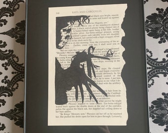 Arte de silueta de página de libro de Eduardo Manostijeras enmarcado