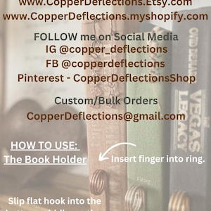 May include: Copper bookmark holder with a ring and a hook. The bookmark is designed to hold a book open. The text on the image reads "How to Use: The Book Holder" and "Insert finger into ring".